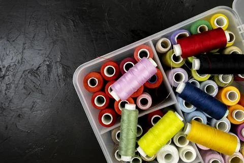 Colored threads on an black background, top view, space for text, copy space Stock Photos