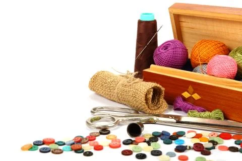 Colored threads, buttons and fabric isolated on white background. Stock Photos