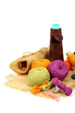 Colored threads, buttons and fabric isolated on white background. Stock Photos