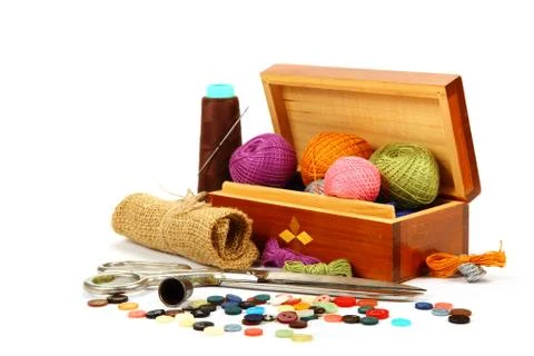 Colored threads, buttons and fabric isolated on white background. Stock Photos