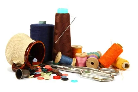 Colored threads, buttons and tailoring scissors. Stock Photos