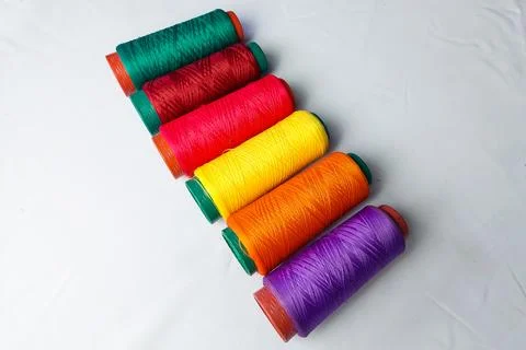 Colored threads lined up on a white background Stock Photos