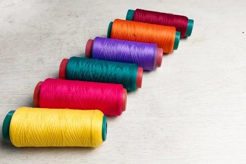Colored threads lined up on a white background Stock Photos