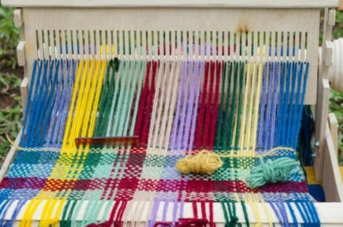 The colored threads in a loom Stockfoto's