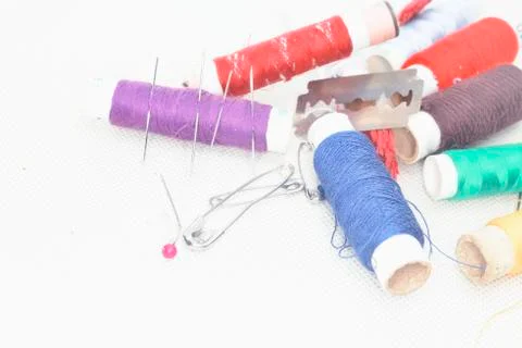 Colored threads with needles and blade Stock Photos
