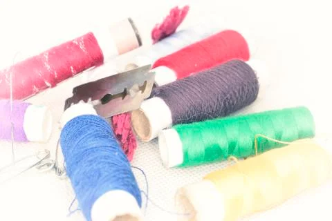 Colored threads with needles and blade Stock Photos