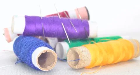Colored threads with needles and blade Stock Photos
