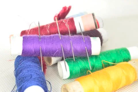 Colored threads with needles and blade Stock Photos