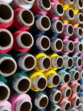 Colored threads in a reel, stack of sewing reels with high angle view Foto stock