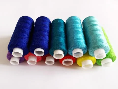 Colored threads for sewing on a white background Stock Photos