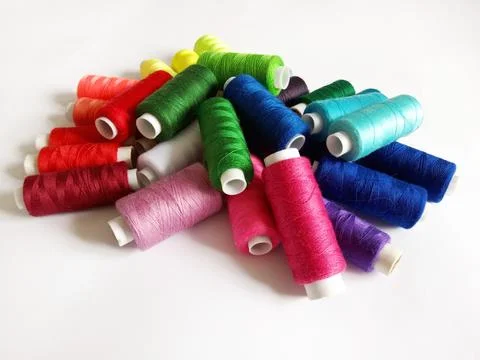 Colored threads for sewing on a white background Stock Photos