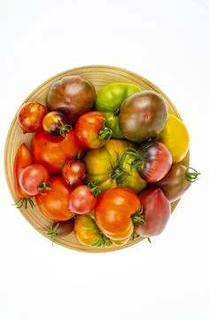 Colored tomatoes of different varieties on white background. Studio Photo Stock Photos