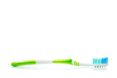 Colored toothbrush on an isolated background, close up Stock Photos
