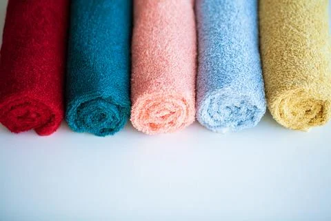 Colored towels on white table with copy space on bath room background. Stock Photos