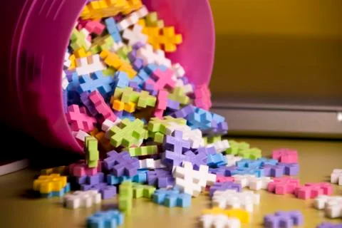 Colored toy constructions that come out of a container Stock Photos