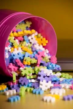Colored toy constructions that come out of a container Stock Photos