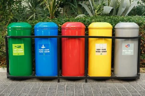 Colored trash containers for garbage separation Stock Photos