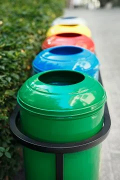 Colored trash containers for garbage separation Stock Photos