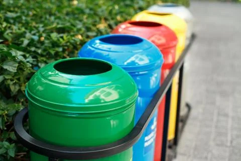 Colored trash containers for garbage separation Stock Photos