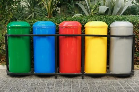 Colored trash containers for garbage separation Stock Photos