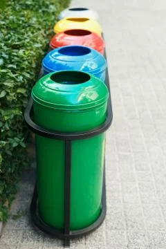 Colored trash containers for garbage separation Stock Photos