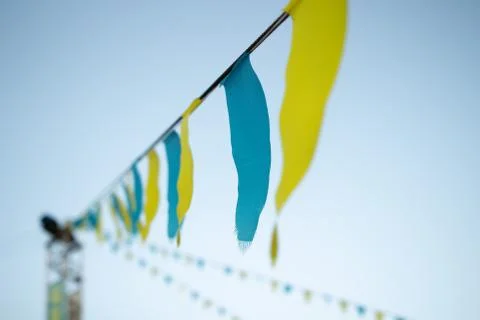 Colored triangle flags on rope line. Lines of Colourful triangle flags along  Stock Photos