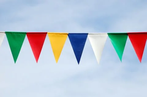 Colored triangular flags on blue sky background 写真素材