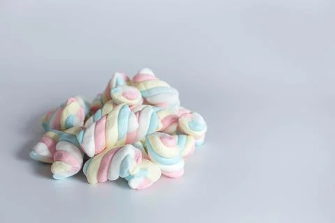 Colored twisted marshmallow on white background. Side view Stock Photos