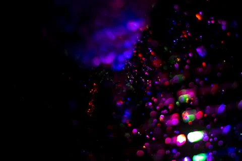 Colored water texture. Splashes of water lit in different colors. Stock Photos