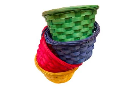 Colored wicker baskets one inside the other on a white background seen from a Stock Photos