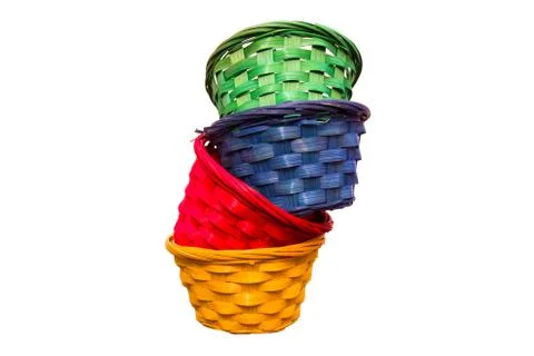 Colored wicker baskets one inside the other on a white background Stock Photos