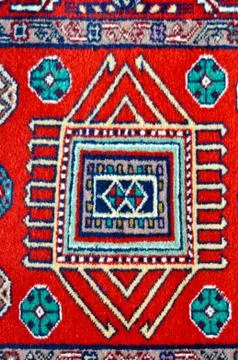 Colored wool handmade carpet closeup Stock Photos