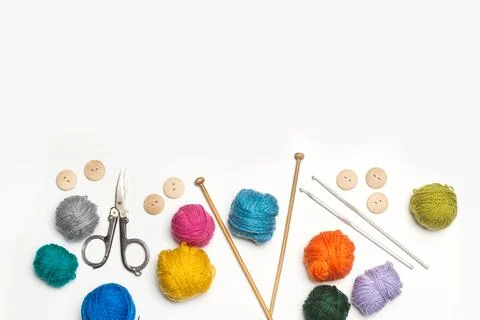 Colored wool spools and crochet hook on a wooden background with copy space Stock Photos