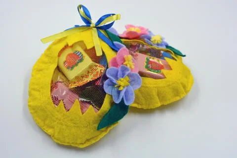 Colored yellow packages with sweets packed in the form of an egg made of fabric Fotos Stock