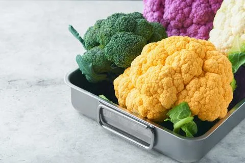 Colorfu cauliflower. Various sort of cauliflower on gray concrete background. Stock Photos