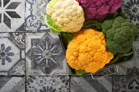 Colorfu cauliflower. Various sort of cauliflower on stone tiles gray concrete Stock Photos