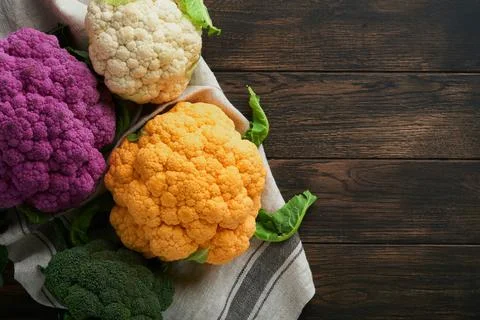 Colorfu cauliflower. Various sort of cauliflower on old wooden background. Pu Stock Photos