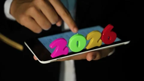Colorful 2026 numbers on tablet for future planning Stock Footage 321937059