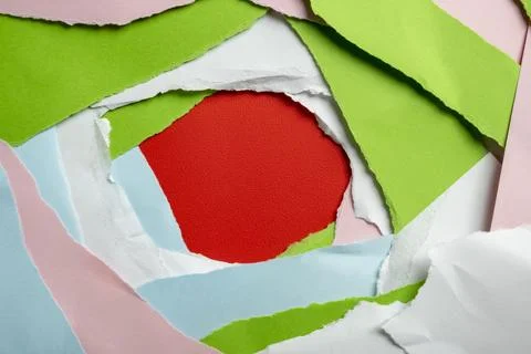 A colorful abstract background featuring multiple layers of torn paper in g.. Stock Photos