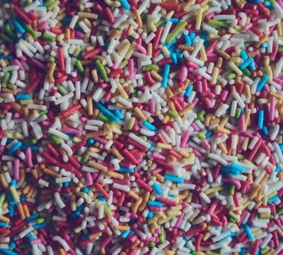 Colorful abstract background texture of sweet sprinkles sugar macro photo Stock Photos