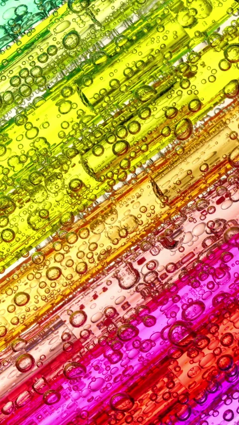 Colorful abstract bubble patterns drifting through bright diagonal rainbow fluid Stock Footage 344979434