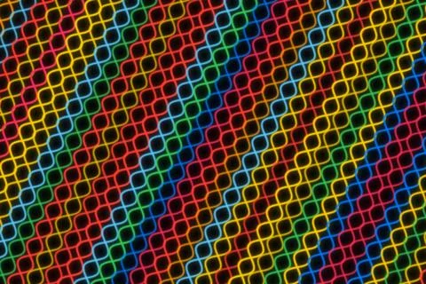 Colorful abstract pattern of neon rings on black background Stock Photos