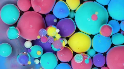 Colorful abstract patterns on a dark surface, showcasing vibrant Stock Footage 288747363