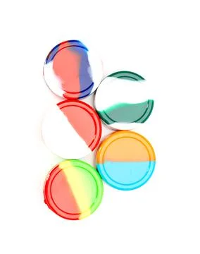 Colorful abstract resin discs arranged on white background Stock Photos