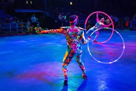 Colorful Acrobatas dancing with hula hoop at Seaworld 1 Stock Photos