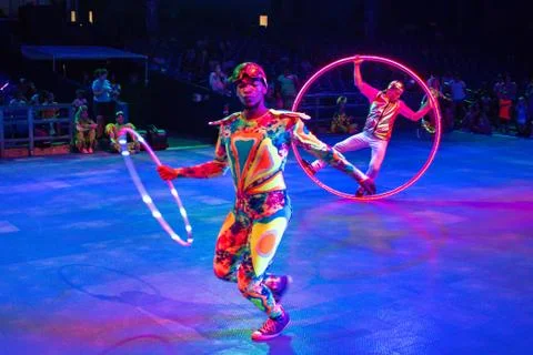 Colorful Acrobatas dancing with hula hoop at Seaworld 2 Stock Photos