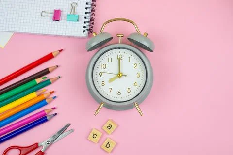 Colorful and Vibrant Study Essentials Featuring an Alarm Clock on a Beautif.. Stock Photos
