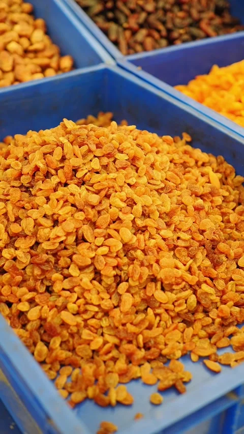 A colorful array of dried fruits is showcased at a bustling market during the Vídeo Stock 345695007