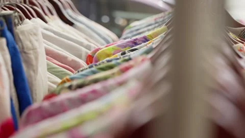 A Colorful Array of Hanging Garments Showcasing Various Textures and Patterns in Stock Footage 310155825