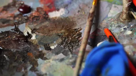 Colorful array of oil paint samples on an artist's palette Stock Footage 241516300